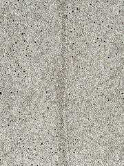 Sand on the Baltic Sea beach in Mrzezyno in Poland after being washed by a wave in close-up as a background