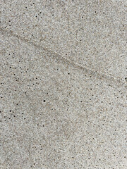 Sand on the Baltic Sea beach in Mrzezyno in Poland after being washed by a wave in close-up as a background