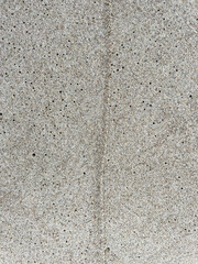 Sand on the Baltic Sea beach in Mrzezyno in Poland after being washed by a wave in close-up as a background