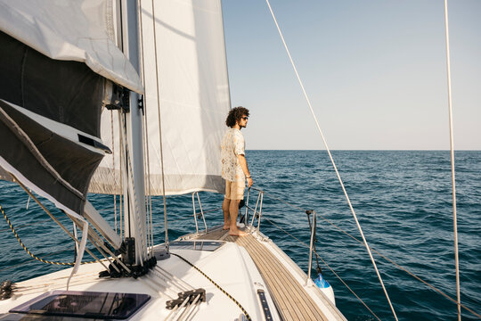 Young man enjoying a sailboat trip on the open sea