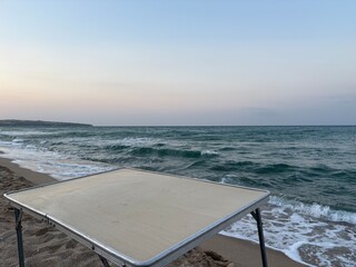 sea and beach, table on the sand with the sea in the background