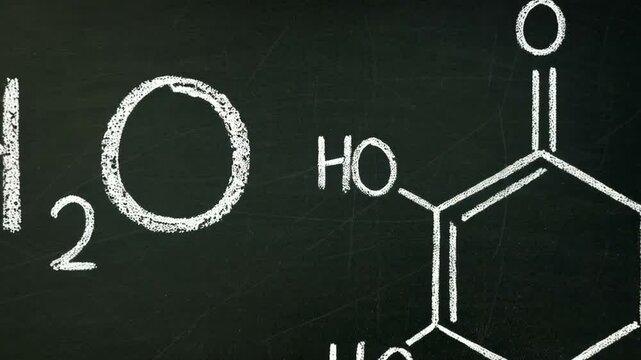 Chemical formula of water and hydroquinone drawn on a chalkboard