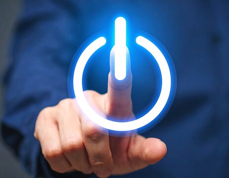 Hand touching a glowing power button