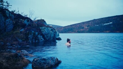 Man Swimming In Fjord In Sleppen, Åfjord, Norway - Wide Shot - Powered by Adobe