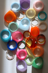 Collection of colorful plastic rings on white background. Top view.