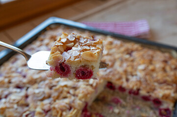 Delicious homemade cherry cake with almonds on a baking tray