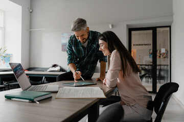 Two coworkers engaging in a productive discussion while working on a project together.