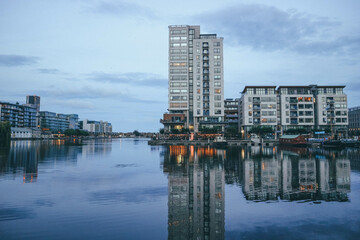 downtown dublin marina skyline with modern buildings and water reflection at night