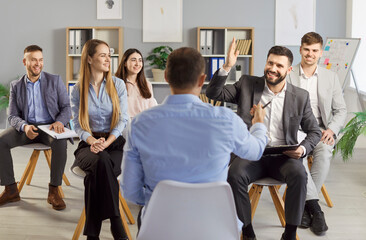 Business coach, male speaker rear view asking team, leader mentor working with diverse business...