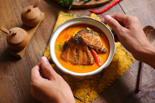 bowl of smoked fish cooked in spicy curry named mangut in Bahasa 