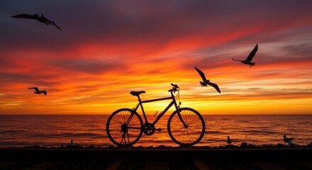 Fototapeta premium Sunset Silhouette of a Bicycle by the Ocean