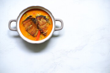 bowl of smoked fish cooked in spicy curry named mangut in Bahasa 