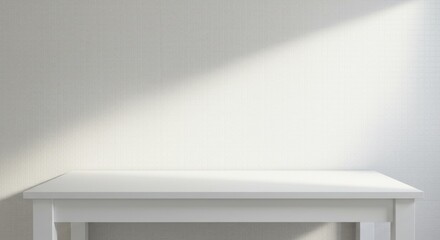 Fototapeta premium A bright minimalist scene showing a plain white table against a textured white wall, illuminated by a diagonal beam of natural light