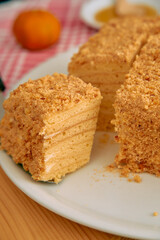 Delicious layered honey cake with crumb topping on a plate