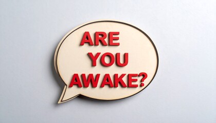 Wooden speech bubble with red letters asking "Are you awake?