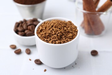 Granulated instant coffee and beans on light table, closeup