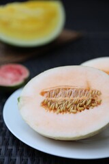 Ripe juicy tropical fruits on wicker table, closeup