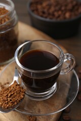 Aromatic hot drink, instant coffee and beans on table, closeup