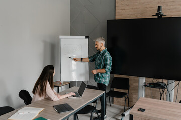 A professional presenting statistical information while collaborating in a modern office