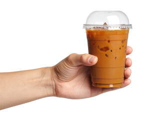 A hand holds a clear plastic cup filled with iced coffee topped with a dome lid.