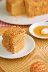 Delectable honey cake slice with citrus and honey drizzle on table setting