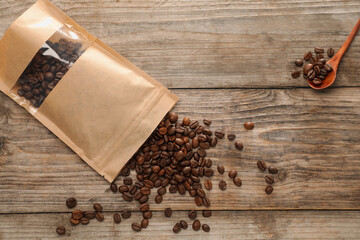 Zipper stand-up pouch with coffee beans on wooden table, flat lay. Mockup for design
