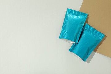 Zipper stand-up pouches on color background, flat lay. Mockup for design