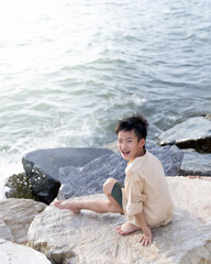 young boy  sitting on the rocks