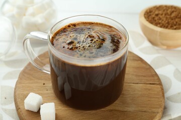 Aromatic instant coffee with sugar on table, closeup