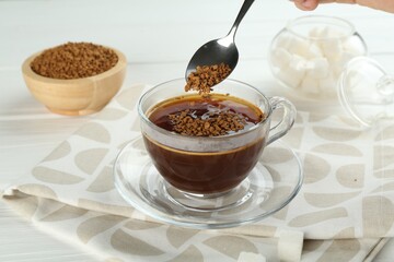 Woman making instant coffee at light table, closeup