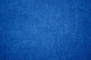 Deep blue textured background. Embossed wall with blue tones