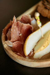 Gourmet platter with prosciutto and pear for elegant appetizer serving
