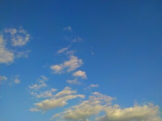 The bright blue sky stretched out with scattered white clouds, illuminated by the sunlight that looked so beautiful.