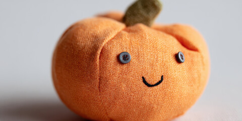 Cute fabric pumpkin with button eyes and smile
