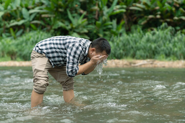  Man meditating with a feeling of river, nature and peace.