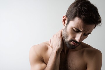 Man holding his neck with pained expression, showcasing discomfort and tension. image captures struggle of dealing with physical pain, emphasizing emotional impact of such experiences