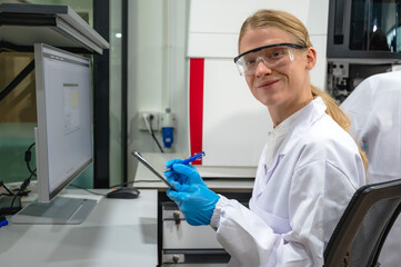 Female specialist medical laboratory scientist working with lab instrument for analyze diagnostic...