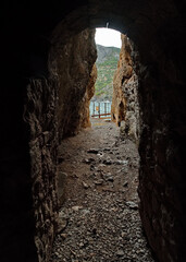 Fototapeta premium Russia, the Crimean Peninsula. Through grotto on Cape Kapchik overlooking the waves of the Black Sea.