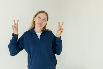 Photo of young attractive girl happy positive smile show peace cool v-sign isolated over white background