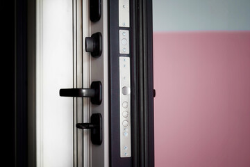 Sturdy apartment entry door ajar, showcasing heavy‑duty lock mechanism and steel construction for...