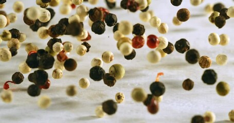 Colorful Peppercorns in Slow Motion Aromatic Spice Mix of Black, White, Red, and Green Pepper Bouncing and Floating, Ideal for Cooking, Culinary Art, and Gourmet Seasoning Concepts at 1000 fps. - Powered by Adobe