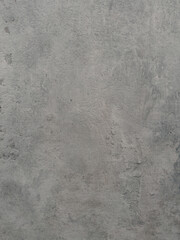 Textured medium grey surface resembling aged concrete or plaster, ideal for backgrounds, industrial design, or material samples