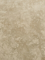 Detailed close-up of a textured light beige surface resembling aged concrete or plaster with subtle variations and marks, perfect for backgrounds