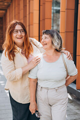 Senior Woman With Adult Daughter posing outdoors