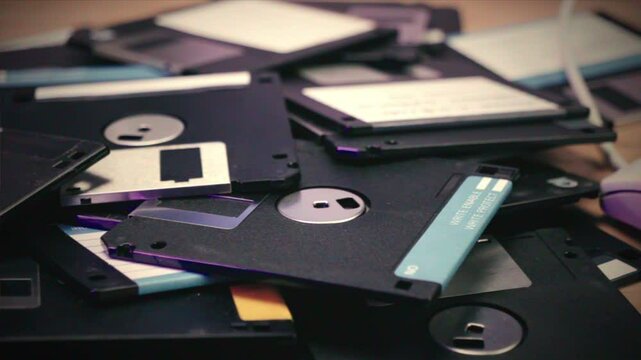 Floppy disc FDD close up, Using diskette for old PC computer macro. Archive programme or Music recorder, playing retro computer games. Vintage device for office, obsolete technology. 