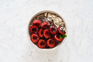 Buckwheat porridge with fresh sweet cherries, berry jam, and almonds. Vegan breakfast bowl