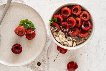 Buckwheat porridge with fresh sweet cherries, berry jam, and almonds. Vegan breakfast bowl