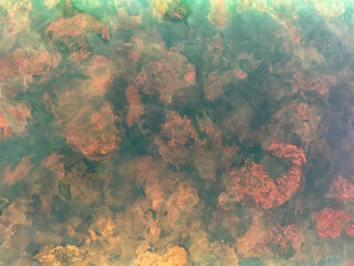 Decorative blue and red textured paint on a surface. Random corroded metal painted with random brush strokes, in metallic blue tosca, with washed, grunge, and dirt pattern. Seamless background texture