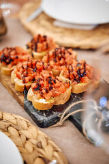 Tomato bruschetta with balsamic drizzle on rustic wooden serving board