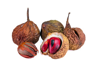 Dried nutmeg fruits with one open showing seed and red mace, isolated on white background, perfect for culinary or herbal use.